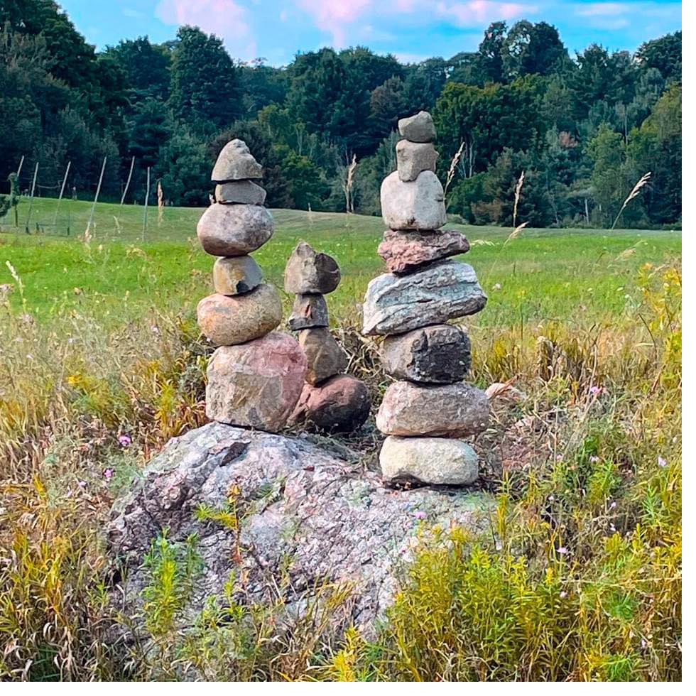Balanced stone cairns on the Balancing Act Hops farm